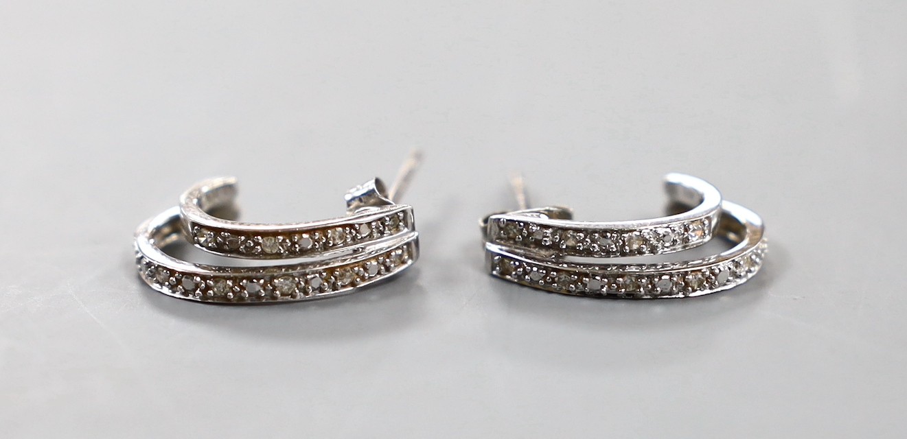 A modern pair of 375 white metal and diamond set two row half hoop earrings, 15mm, gross 2.1 grams.